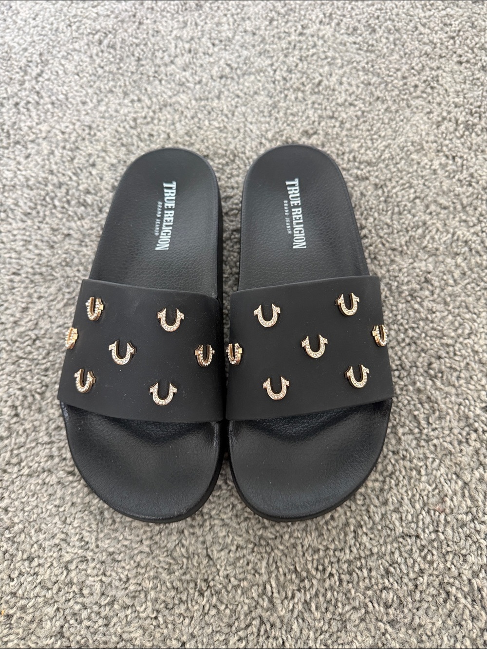 True Religion Black Slide Sandals with Gold Horseshoe Accents